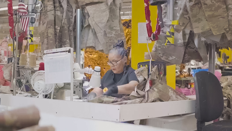 Women working at a desk in a factory