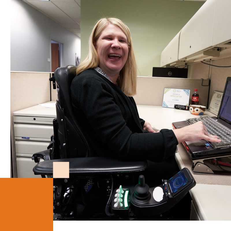 Year in Review Career woman in cubicle on keyboard