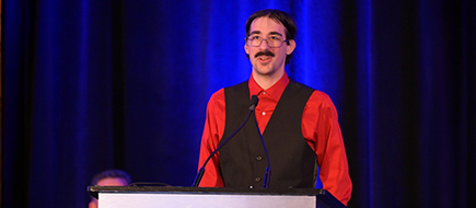 Male advocate speaking at a podium