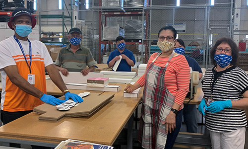 MDI employees assemble USPS plastic bins.