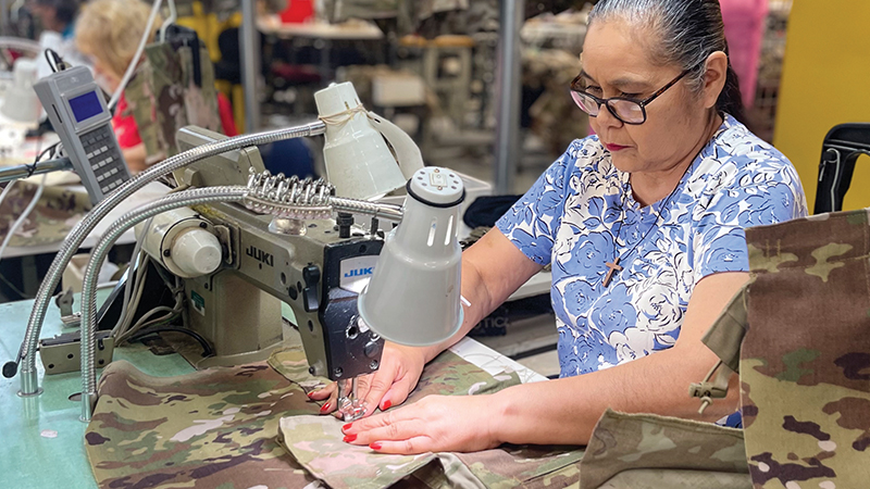 Increasing Capability through Automation Woman at sewing machine making military clothing