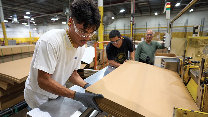 Creating Jobs Man working machinery in factory