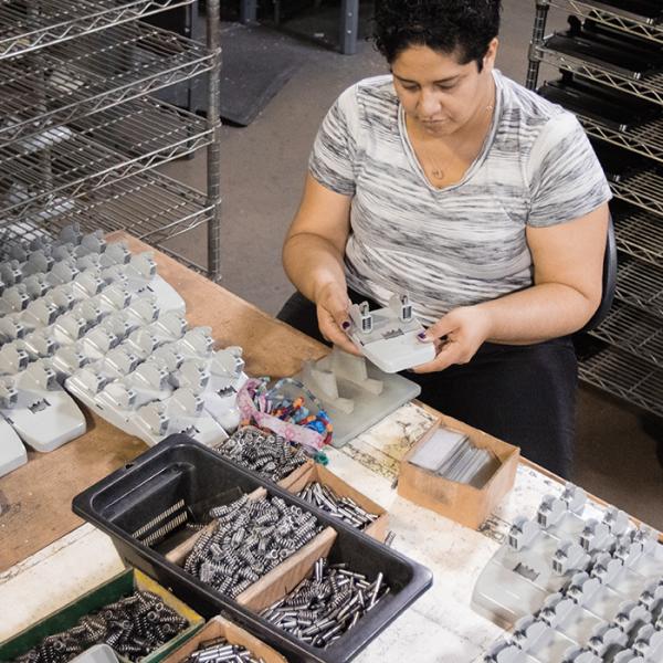 Employee assembling office supplies