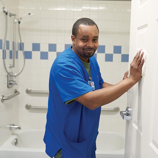 Employee Cleaning in Bathroom