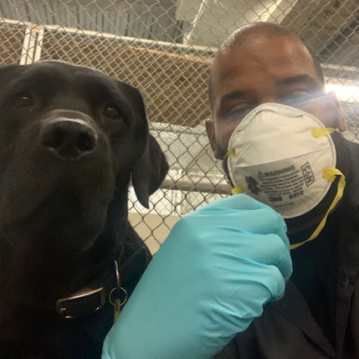 Michael Haynes takes a ‘selfie’ with one of the many dogs he cares for at JFK