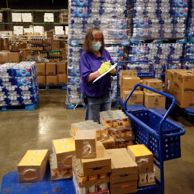 Desiree Ralston takes inventory during her shift at the Commissary