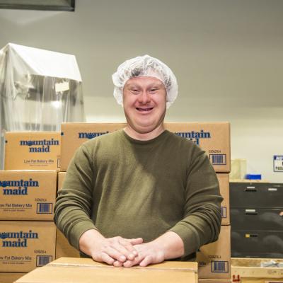 James Owen posing in front of TVS’ Baking Mix 