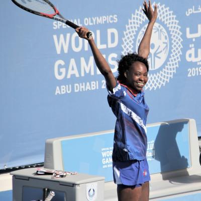 Krystal playing Tennis at the special Olympics